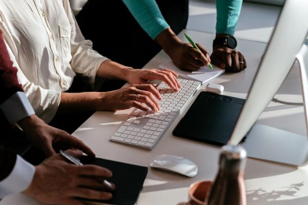 Employés de bureau réunis autour d'un ordinateur portable